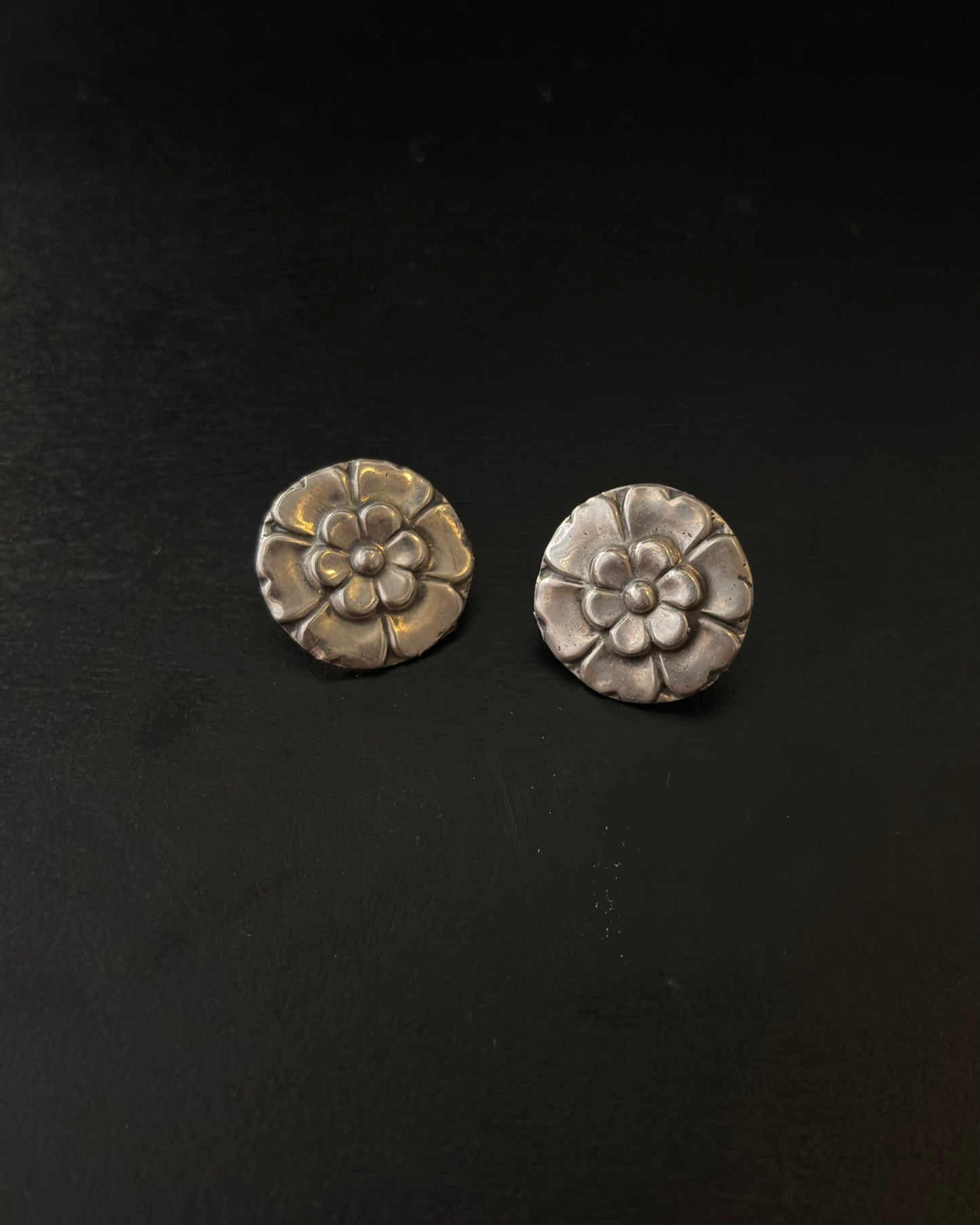 Pair of silver floral earrings on a black background, 92.5 silver earrings
